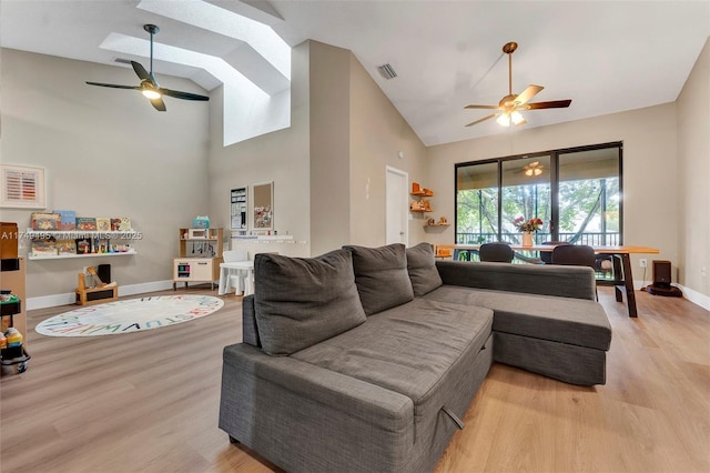 123 NW 98th Ter, Plantation, FL 33324 - living area featuring visible vents, baseboards, ceiling fan, light wood-type flooring, and high vaulted ceiling