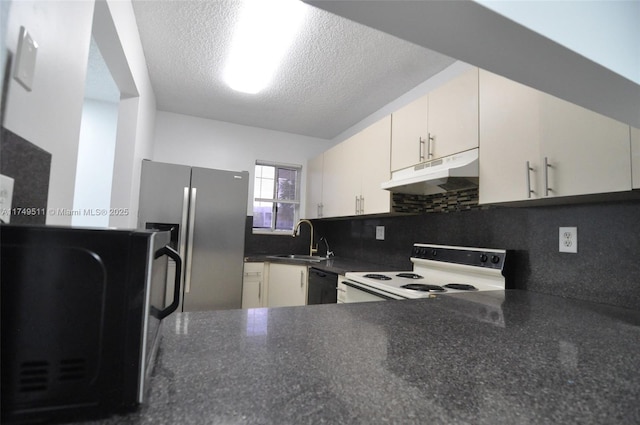 kitchen with black dishwasher, electric stove, dark countertops, stainless steel fridge, and under cabinet range hood