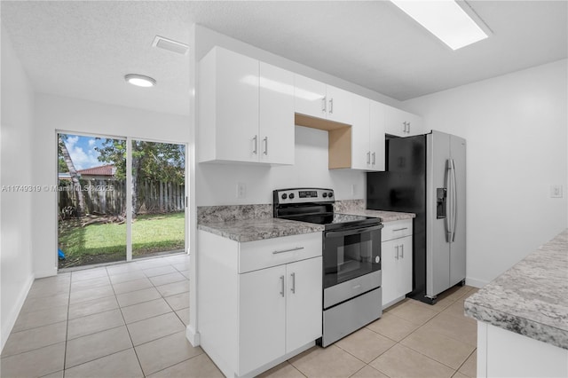 kitchen featuring stainless steel appliances, light countertops, visible vents, white cabinets, and light tile patterned flooring