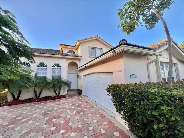 mediterranean / spanish-style house with a tiled roof and stucco siding