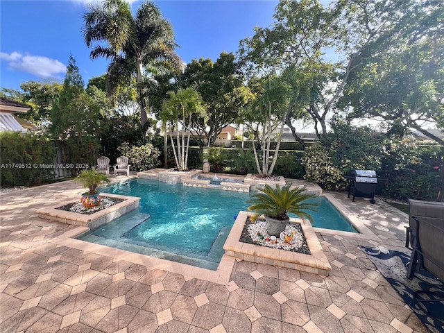 view of swimming pool with a patio area, a grill, fence, and a fenced in pool