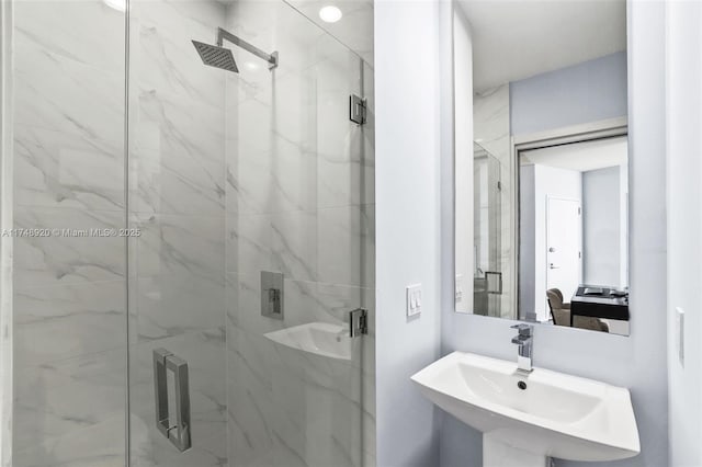 full bathroom with a sink and a marble finish shower