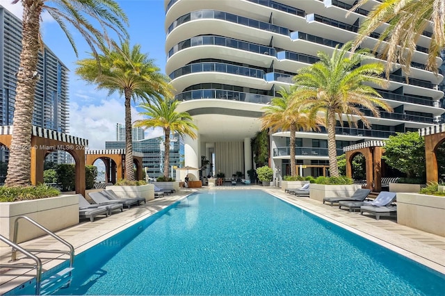 pool featuring a view of city and a patio