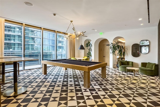 recreation room featuring arched walkways, pool table, expansive windows, and recessed lighting