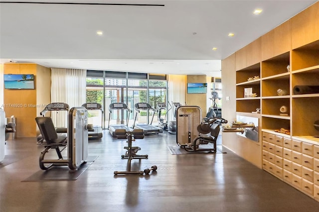 workout area featuring a wall of windows and recessed lighting