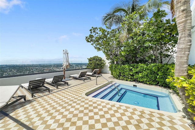 view of pool featuring a water view, a patio, and a hot tub