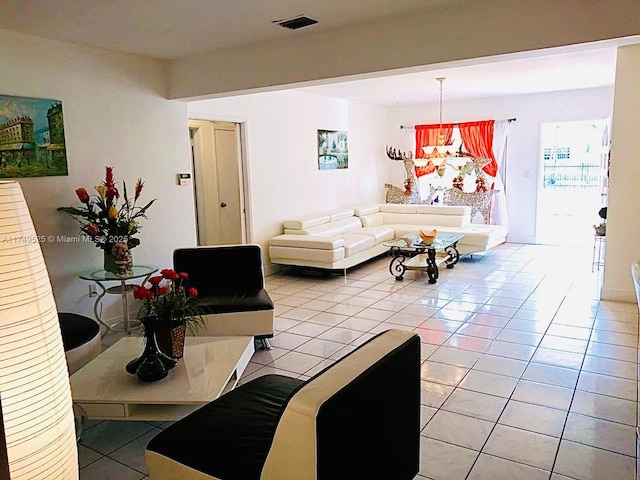 living room with light tile patterned floors, a chandelier, and visible vents