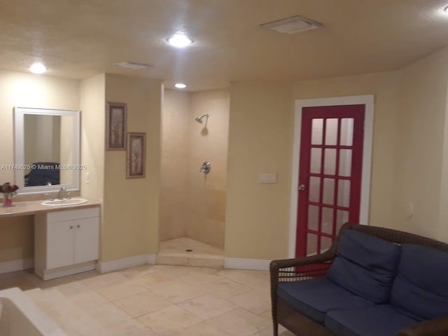 full bathroom featuring recessed lighting, visible vents, a tile shower, vanity, and baseboards