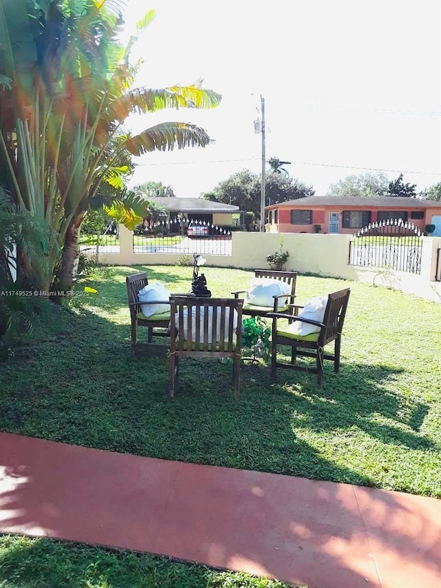 view of home's community featuring a lawn and fence