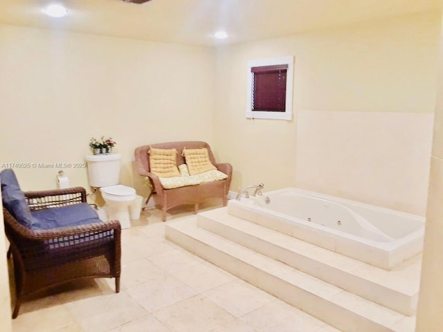 full bathroom featuring tile patterned flooring, toilet, and a whirlpool tub