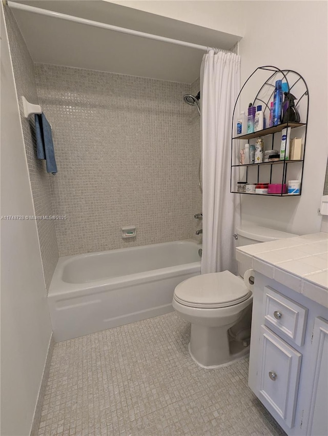 full bathroom with shower / tub combo with curtain, toilet, vanity, baseboards, and tile patterned floors