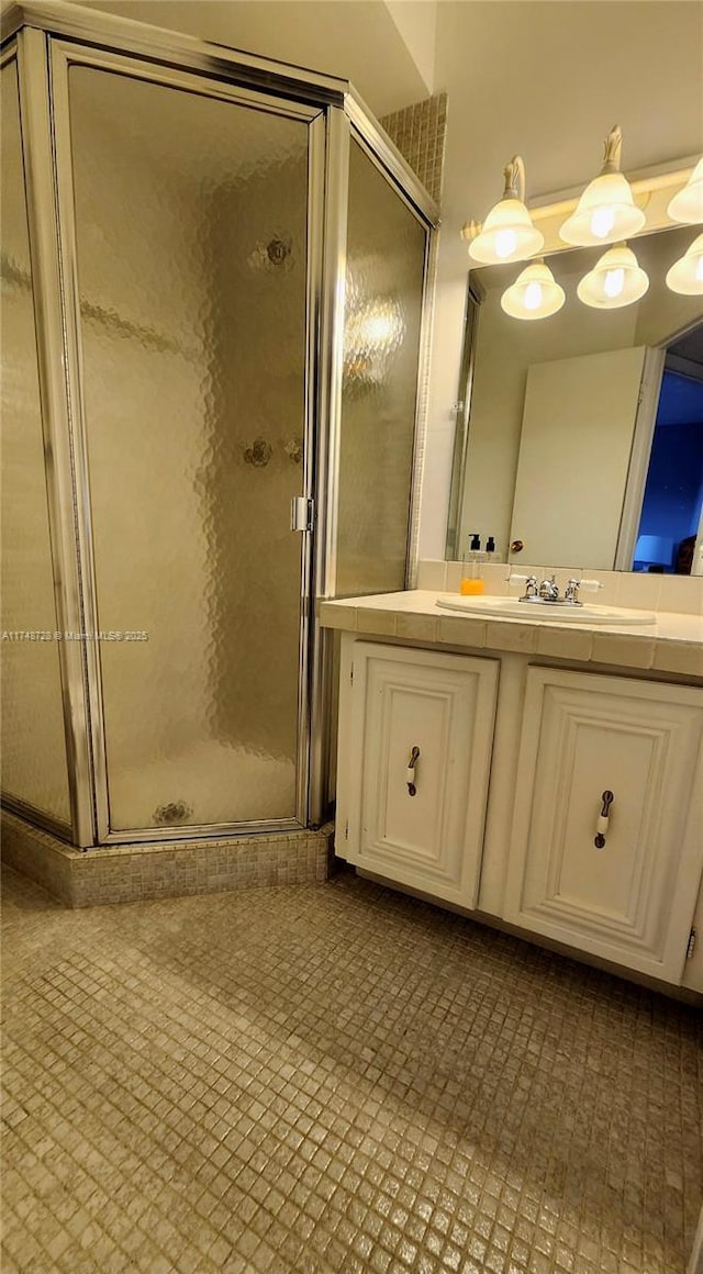 full bath with a shower stall and vanity