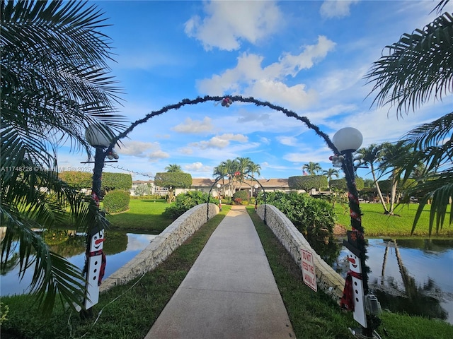 surrounding community with a yard and a water view