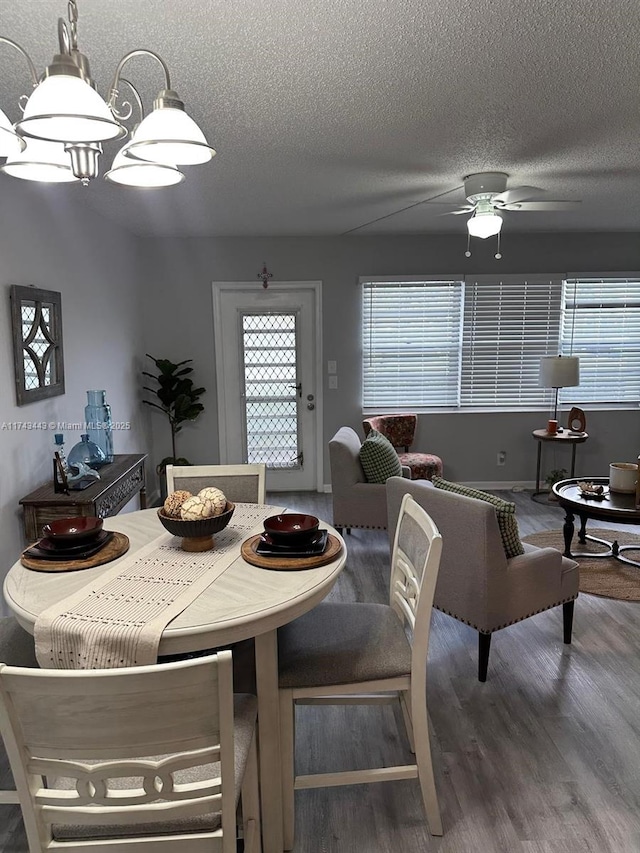 dining space featuring ceiling fan, a textured ceiling, and wood finished floors