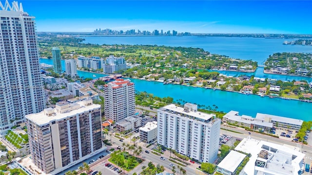 drone / aerial view featuring a city view and a water view