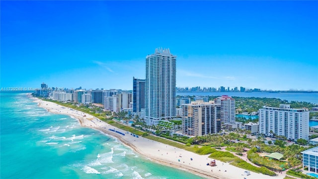 birds eye view of property featuring a beach view, a water view, and a view of city