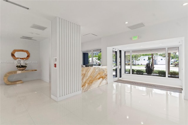 hall featuring baseboards, tile patterned flooring, visible vents, and recessed lighting