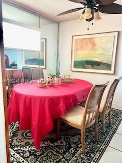 tiled dining space with a ceiling fan