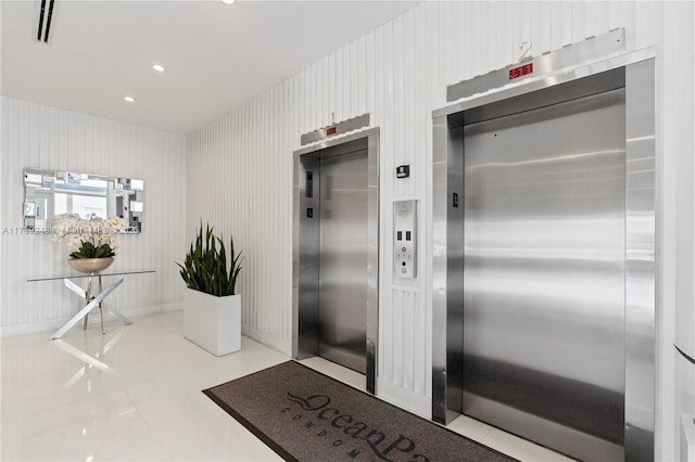 property entrance featuring elevator and visible vents