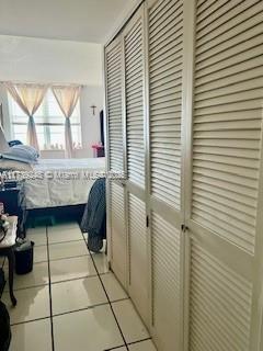 interior space featuring light tile patterned floors and a closet