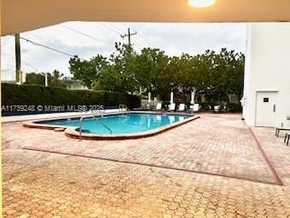 community pool with a patio area