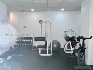 exercise room featuring a paneled ceiling