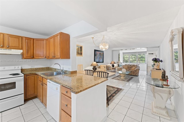 kitchen with light tile patterned floors, open floor plan, a sink, white appliances, and under cabinet range hood