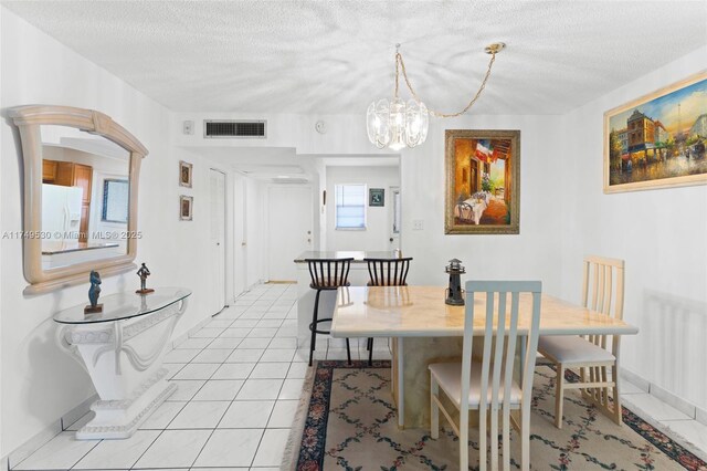 445 NE 195th St Unit 324, Miami, FL 33179 - dining space featuring light tile patterned floors, visible vents, and a textured ceiling