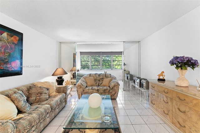 445 NE 195th St Unit 324, Miami, FL 33179 - living room with a textured ceiling and light tile patterned floors