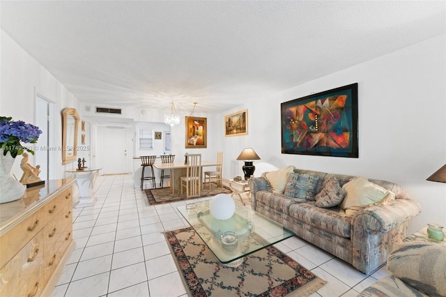 445 NE 195th St Unit 324, Miami, FL 33179 - living area featuring light tile patterned floors, visible vents, and a textured ceiling