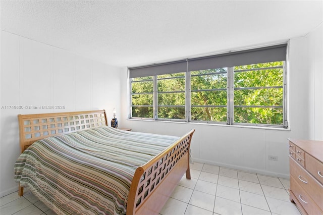 445 NE 195th St Unit 324, Miami, FL 33179 - bedroom with multiple windows, a textured ceiling, and light tile patterned flooring