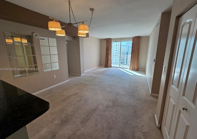 spare room with carpet floors and baseboards