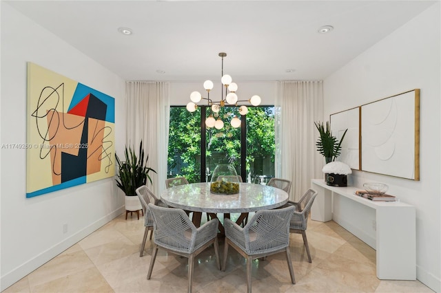 dining area featuring baseboards and an inviting chandelier