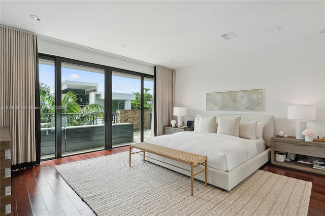 bedroom with access to exterior, visible vents, and wood finished floors