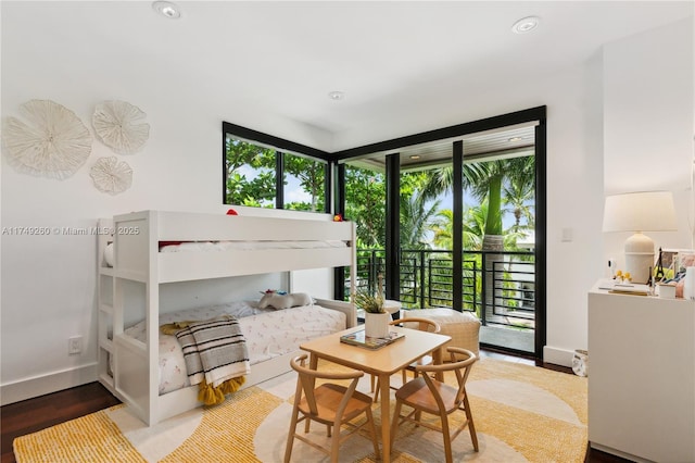 bedroom with access to exterior, expansive windows, baseboards, and multiple windows