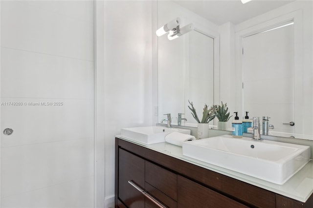 full bathroom featuring double vanity and a sink