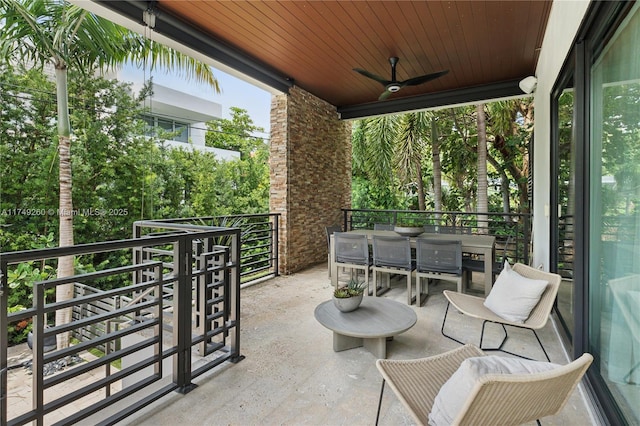 view of patio / terrace featuring outdoor dining area, a balcony, and a ceiling fan