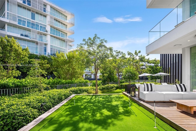 view of yard featuring outdoor lounge area and fence