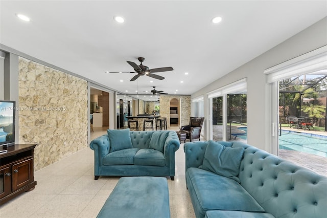 living room featuring a ceiling fan and recessed lighting