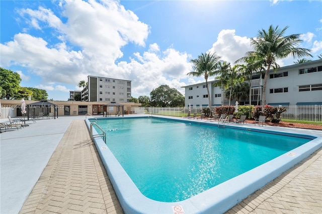 pool featuring a patio area, fence, and a gazebo