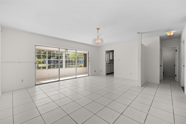 17084 SW 112th Ct Unit V3142, Miami, FL 33157 - unfurnished room with a chandelier, light tile patterned flooring, a sink, and baseboards