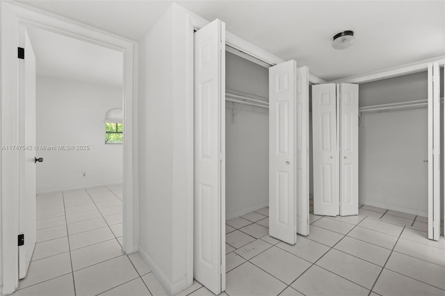 17084 SW 112th Ct Unit V3142, Miami, FL 33157 - unfurnished bedroom featuring multiple closets and light tile patterned floors