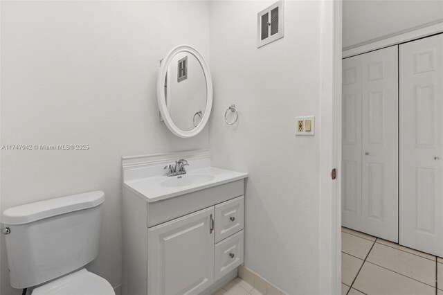 17084 SW 112th Ct Unit V3142, Miami, FL 33157 - bathroom with vanity, toilet, tile patterned flooring, and a closet