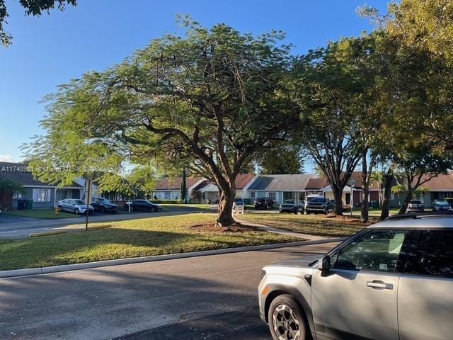 view of street featuring a residential view and curbs