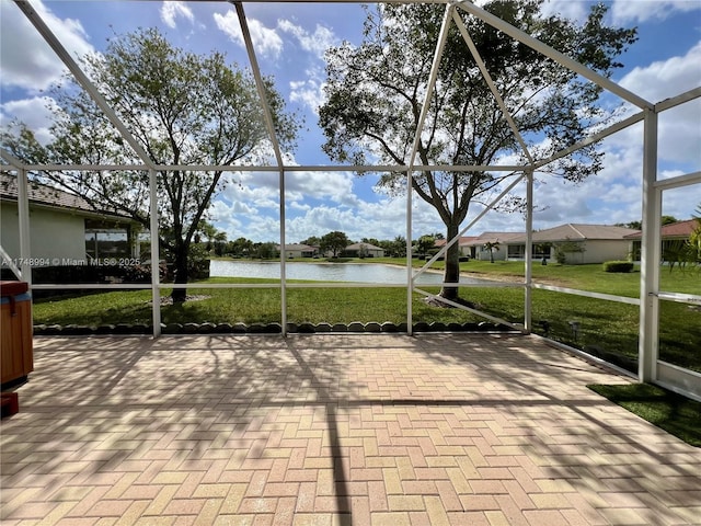 unfurnished sunroom featuring a water view