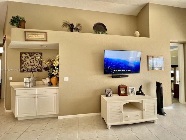 living room featuring light tile patterned floors and baseboards