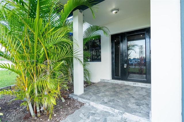 entrance to property with stucco siding