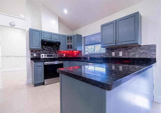 28451 SW 164th Ave, Homestead, FL 33033 - kitchen with stainless steel electric range oven, a peninsula, under cabinet range hood, vaulted ceiling, and glass insert cabinets