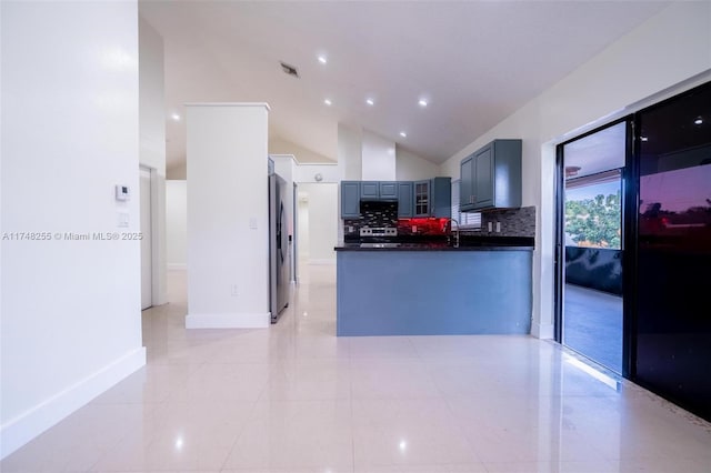 28451 SW 164th Ave, Homestead, FL 33033 - kitchen featuring dark countertops, lofted ceiling, decorative backsplash, light tile patterned floors, and appliances with stainless steel finishes