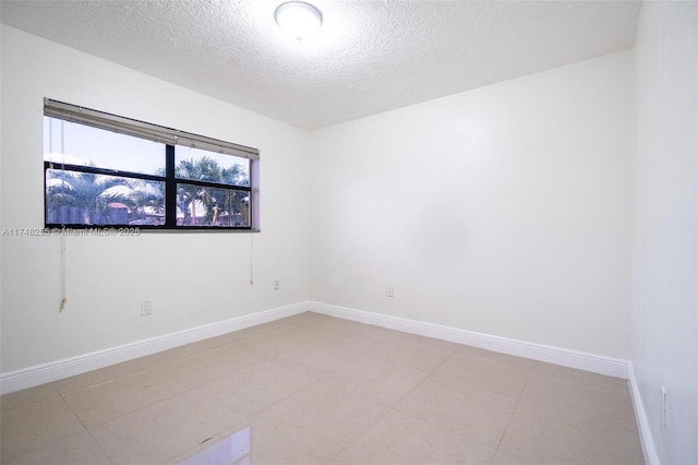28451 SW 164th Ave, Homestead, FL 33033 - empty room with a textured ceiling and baseboards